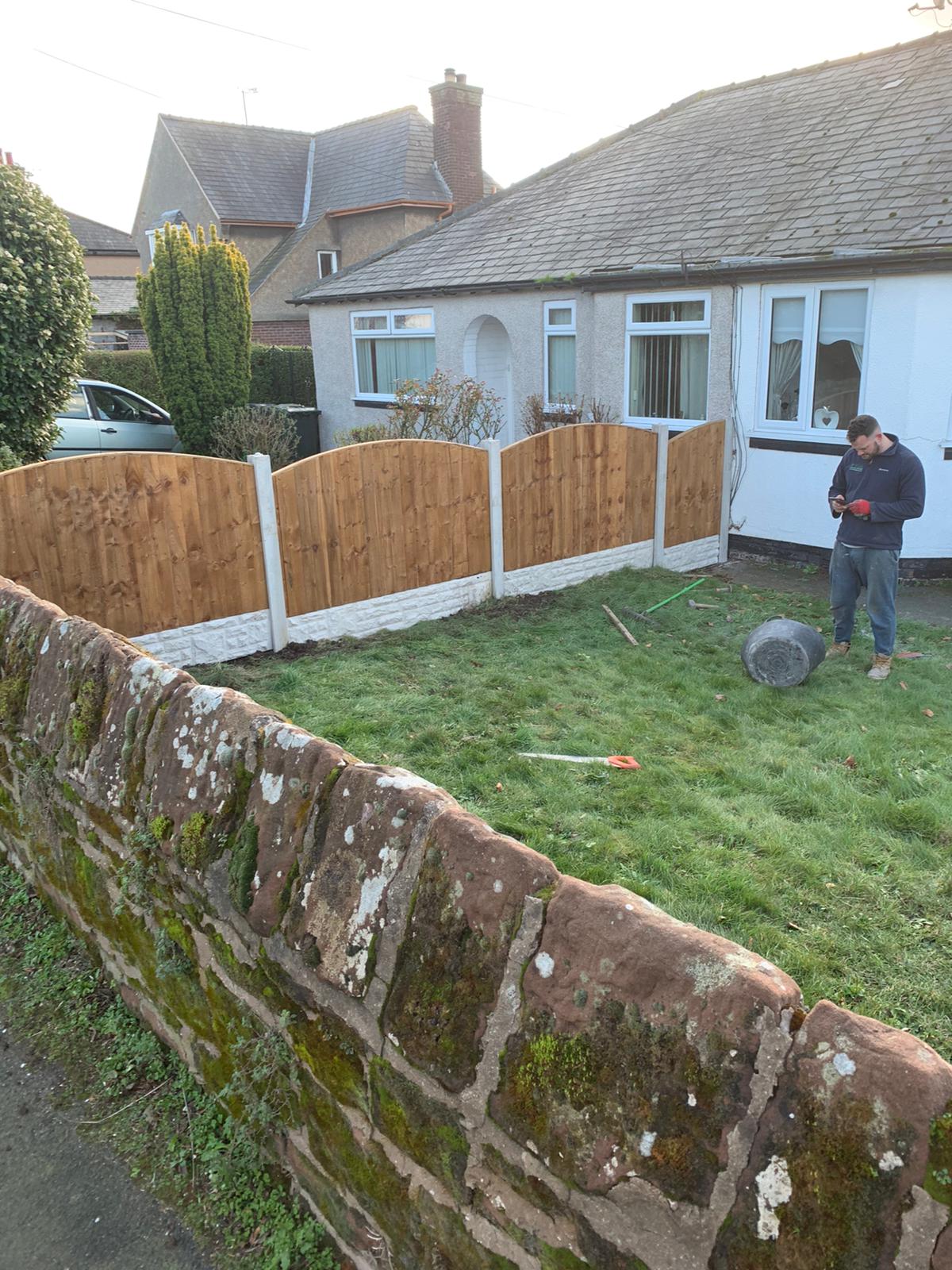 Heswall low rounded top panel feather board fence